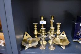 Six pairs of brass candle sticks including push bottom and chamber stick style