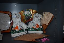 A pair of mirrored Staffordshire flatbacks of lions over dead men and three Chinese style fans