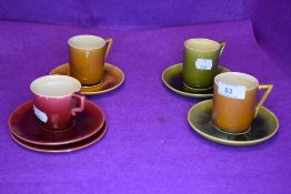 Three coffee cans, five saucers and one tea cup by Linthorpe pottery in designs by Christopher
