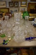 A selection of clear cut and crystal glass wares including cocktail stirrer decanter and lidded