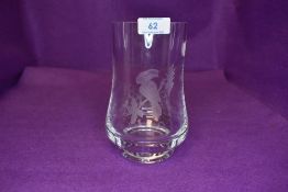 An art glass vase etched with a toucan bird