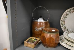 An oak cased tobacco jar and a similar biscuit barrel