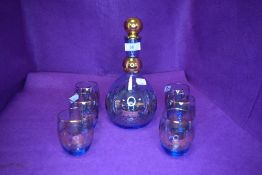 An Italian decanter and glass set by Special Murano having blue glass with gilt detailing