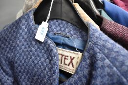 A collection of ladies retro skirt suits and jackets, different colours and styles.