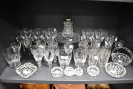 A good selection of crystal clear blown cut and etched glass wares including cocktail and cordial