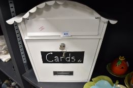 A modern metal bodied letter box having lock and key
