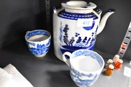 An antique hand decorated porcelain tea pot and two similar tea cups