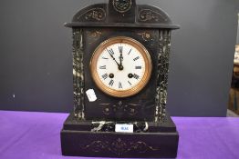 An antique marble mantel clock having roman numerals to enamel face and engraved detailing to