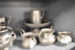 A footed bowl by English Pewter having hammered effect and similar items including Tiel of Holland
