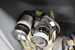 A Canon T70 camera body with Vivitar Macro 1:3.5-4.8 lens and Vivitar 1:4.2 - 5.8 Macro