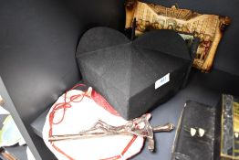 A selection of religious items including mitre hat and cast crucifix