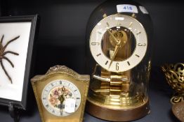 A skeleton style brass anniversary clock by Kundo and similar mantle clock