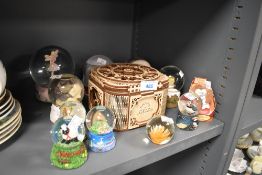 A selection of winter snow globes and a puzzle style box by Ugears