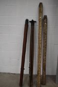 Two vintage surveyors staffs and two wooden tripods, possibly theodolite stands, one stamped