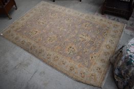 A traditional rug, light colours and quite faded, approx 180 x 120cm