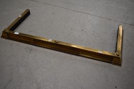 An adjustable brass fire fender