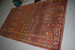 A Turkish style wool carpet in shades of orange, approx 310 x 170cm