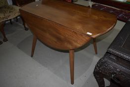 A mid stain Ercol drop leaf (sprung) table on splay legs , width approx 113cm
