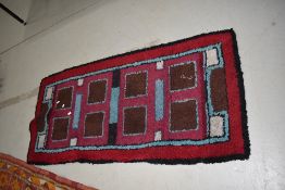 A traditional wool rug in shades of burgundy brown and sky blue , approx. 150 x 72cm