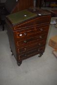 A 19th Century rosewood ladies davenport of compact design having swivel top, and brass gallery