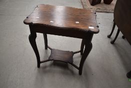 A late Victorian oak occasional table having shaped top and undertier, width approx. 61cm