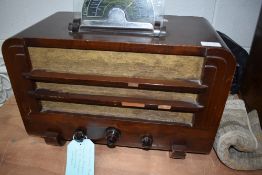 A 1930s Ultra wireless radio, having mahogany ply case, bakelite knobs and glass dial