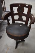 A 'britannia' chair having metal swivel base