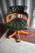 A reproduction button back office armchair in green leather