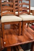 A nice quality modern hardwood dining table having plank effect top, on chunky square legs and