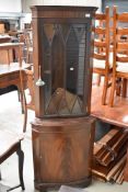 A reproduction Regency mahogany corner display cabinet