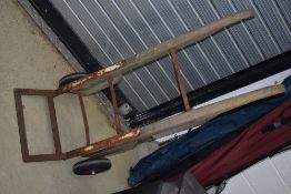 A vintage sack or luggage bogey, railway style having wooden frame and solid wheels