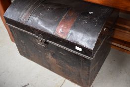 A traditional tin trunk having dome top