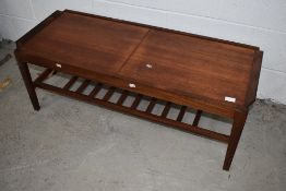 A vintage teak slide top style coffee table with concealed melamine centre section and railed