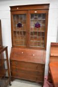 A late 19th or early 20th Century oak bureau bookcase