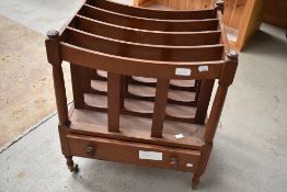 A reproduction mahogany Canterbury style magazine rack having drawer base
