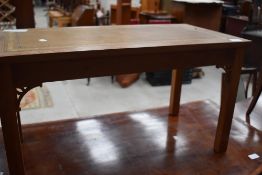 A vintage coffee table having inset top and teak frame