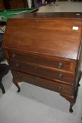 A reproduction mahogany bureau having three drawer set