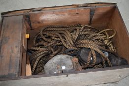 A selection of vintage block and tackle style pulleys, with ropes and a wooden tool box