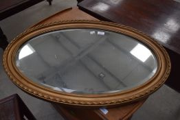 A gilt frame oval wall mirror