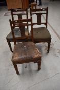 A set of three Victorian oak framed dining chairs having pokerwork and carving to back pabel,