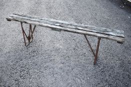 A rustic garden or similar form having metal frame and wooden slat top