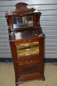 A Victorian mahogany music cabinet, with mirror back , lined and labelled shelves