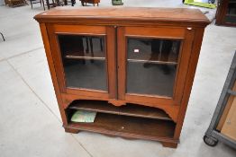 A 19th Century mahogany bookcase , glazed section over two open shelves , possibly on later base,