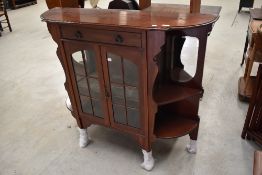 A late Victorian Dresser base having velvet and mirror back with glazed cupboard under