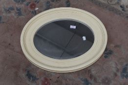 A modern oval wall mirror , approx. 54 x 44cm