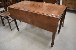 A Victorian mahogany pembroke table having turned frame