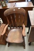 A traditional stained frame farmhouse rocking chair of small proportions