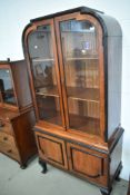 An early 20th Century low countries style hardwood and ebonised display cabinet having double