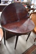 A 19th Century mahogany and inlaid fold over tea table, of demi lune form, on tapered legs, nice