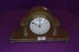 A brass cased late Victorian mantle clock having enamel face dial marked Made In France